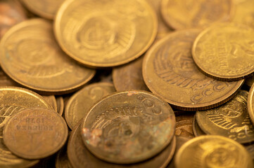 Old coins out of circulation in bulk, background image, close-up, selective focus.