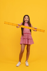 Fototapeta na wymiar amazed teen girl hold ruler. back to school. algebra and geometry. kid study math.