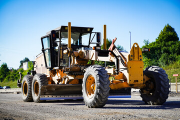 Road grader - heavy machine for earth moving and arrange the slope of the road