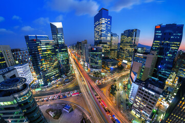 Fototapeta na wymiar Traffic speeds through an intersection at night in Gangnam, Seoul in South Korea.