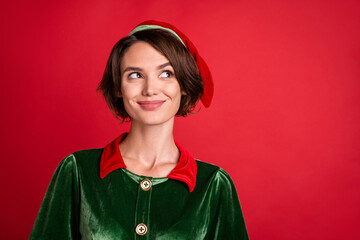 Photo of dreamy thoughtful pretty lady look empty space wear elf costume hat isolated red color...
