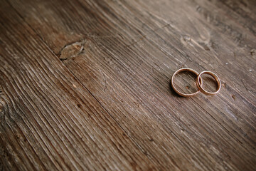 wedding rings on a wooden table
