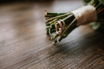 wedding rings with a flower boutonniere

