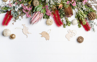 Christmas Background decorated with Australian native wooden animals and flowers - Eucalyptus...