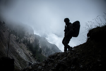 Military in the mountains. Silhouette of marching in the mountains