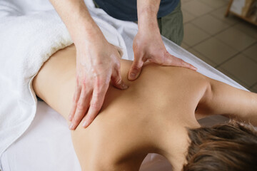 Fototapeta na wymiar massage on the back of a girl 