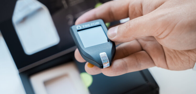 Russia Moscow 12.06.2021 Unpacking of box Trezor hardware,software pocket wallet.Accessory kit,password sheet.Safe,secure vault of cryptocurrency,coins,tokens,nft digital assets.Storage for login,key