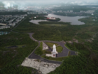 Top view of the Monument to the defenders of the Soviet Arctic during the Great Patriotic War, popularly called Alyosha and the panorama of the city of Murmansk. Russia.