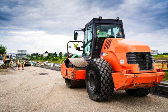 Road roller in the process of repairing and paving road.