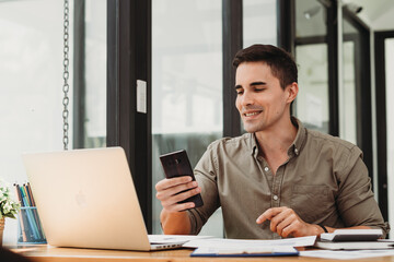 Fototapeta premium caucasian business man working with documents and laptop.