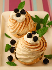 Meringues with cream and blackberries.
