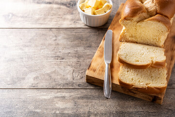 Braided egg bread on wooden table. Copy space
