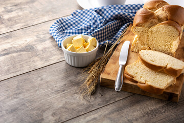 Braided egg bread on wooden table. Copy space