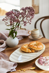 Stylish dining table composition with elegant tableware and beautiful kitchen and personal accessories. Beauty in the details. Template.