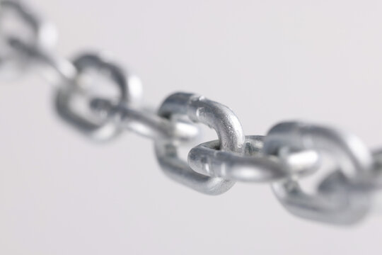 Chromed metal chain links in air closeup