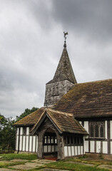Fototapeta na wymiar Ancient half timbered church with spire