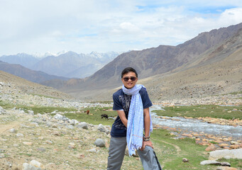 Asian traveler standing on mountain