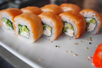 a set of Philadelphia rolls on a white plate. Japanese cuisine. 