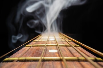 Guitar fretboard against dark background