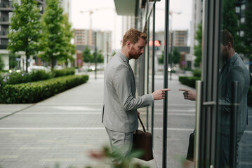 Young businessman with briefcase. Handsome man in suit outdoors