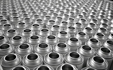 Top view of empty aerosol cans in busy manufacturing factory