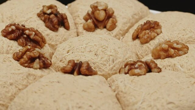Sweet turkish dessert halva block with nuts, close-up