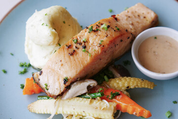 tasty salmon, mash potato and vegetable on plate 