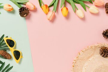 Creative flat lay of travel vacation spring or summer tropical fashion. Top view beach accessories on pastel green pink color background with blank space for text. Top view copy space photography.