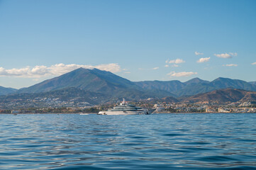 starboard side of a luxury mega yacht of more than 100 meters docked outside of puerto banus....