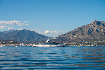 starboard side of a luxury mega yacht of more than 100 meters docked outside of puerto banus....