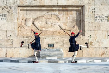 Fotobehang Evzones (soldiers of the greek Presidential Guard) in front of the monument of the Uknown Soldier's tomb in front of the greek parliament. © isandro75