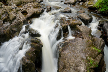 Fototapeta na wymiar Water flowing over rocks in a river