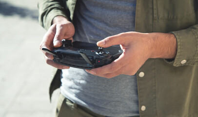 Man holding a remote control of drone. © andranik123