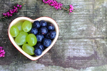 fresh blueberries and grapes in heart shaped dish