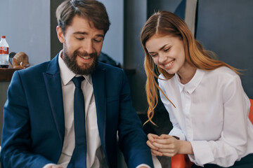 man and woman in business suits communicate with the tablet officials teamwork