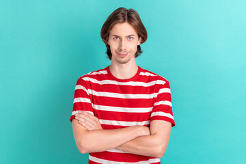 Portrait of attractive cheery cunning guy folded arms isolated over bright teal turquoise color...