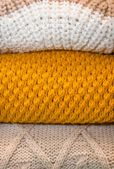 macro texture of three sweaters. fabric fiber yellow, brown and white background