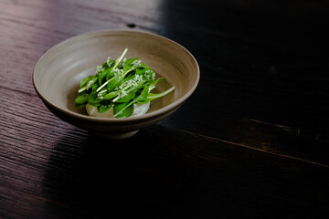 Dish of cottage cheese and garden greens with flowers made at a restaurant