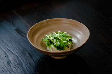 Dish of cottage cheese and garden greens with flowers made at a restaurant