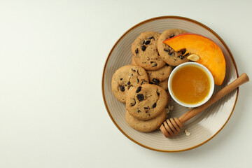 Concept of tasty food with pumpkin cookies on white background