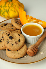 Concept of tasty food with pumpkin cookies on white background