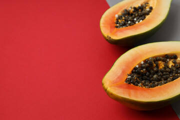 Halves of papaya on two tone background