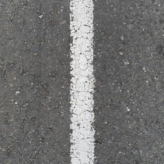 Fototapeta premium a fragment of an old road surface or asphalt with a white dividing line, texture, pattern or source