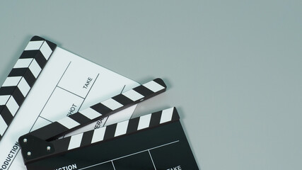 Fototapeta na wymiar Black and white Clapperboard or clapper board or movie slate use in video production ,film, cinema industry on gray background.