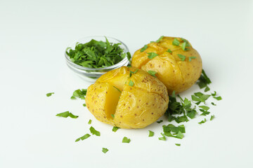 Baked potato with parsley on white background