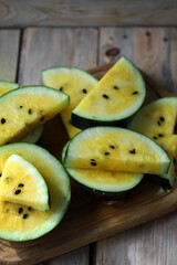 Yellow watermelon slices with seeds.