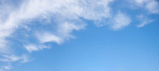 Naklejka na ściany i meble blue sky with fluffy clouds in the diagonally upper half
