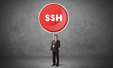 Fototapeta premium Young business person holdig traffic sign