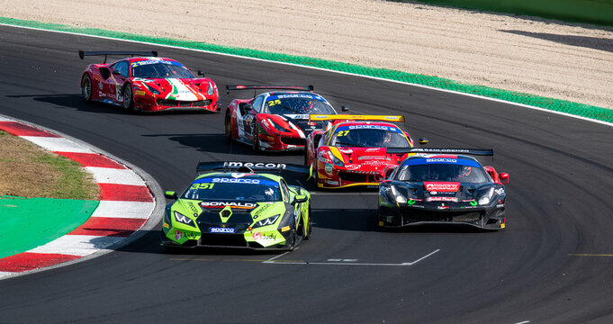 Scenic challenge race between Lamborghini Huracan and group of Ferrari 488 gt cars overtaking during endurance competition