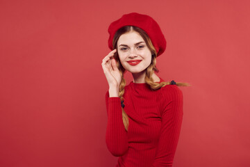 Fototapeta premium beautiful woman with a red cap on his head glamor studio posing
